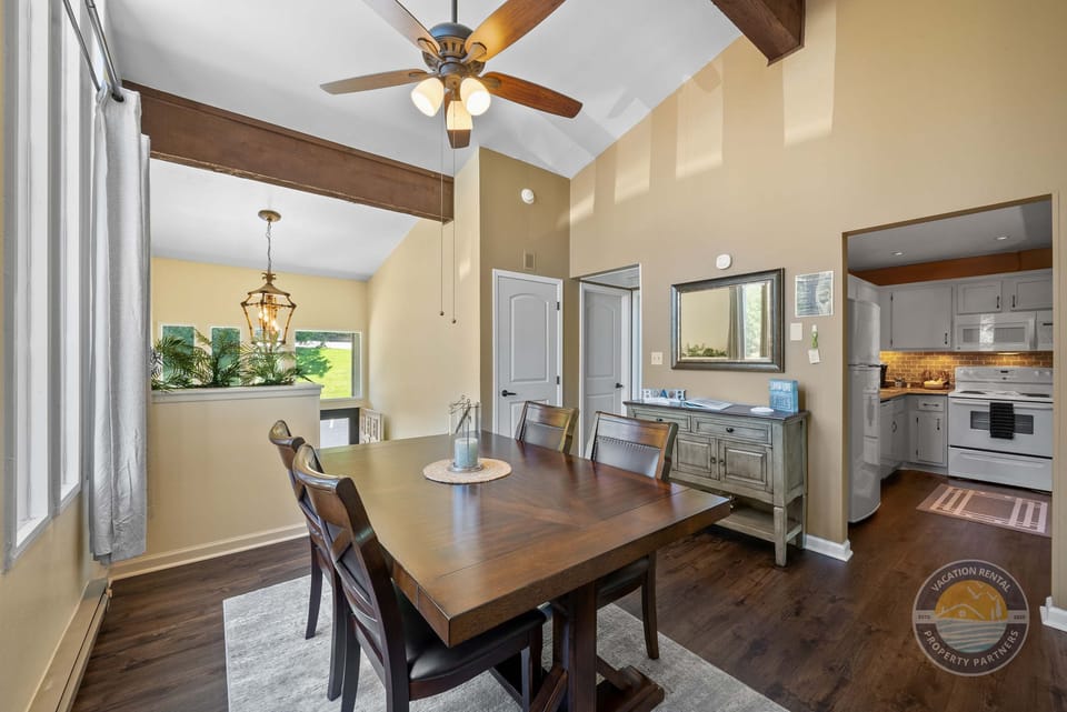 Savor your meals at the dining table with a view of the kitchen