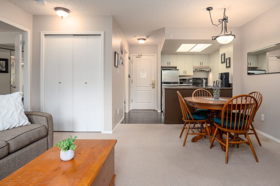 The open-plan living room is designed for comfort, with a plush sofa and cozy gas fireplace.