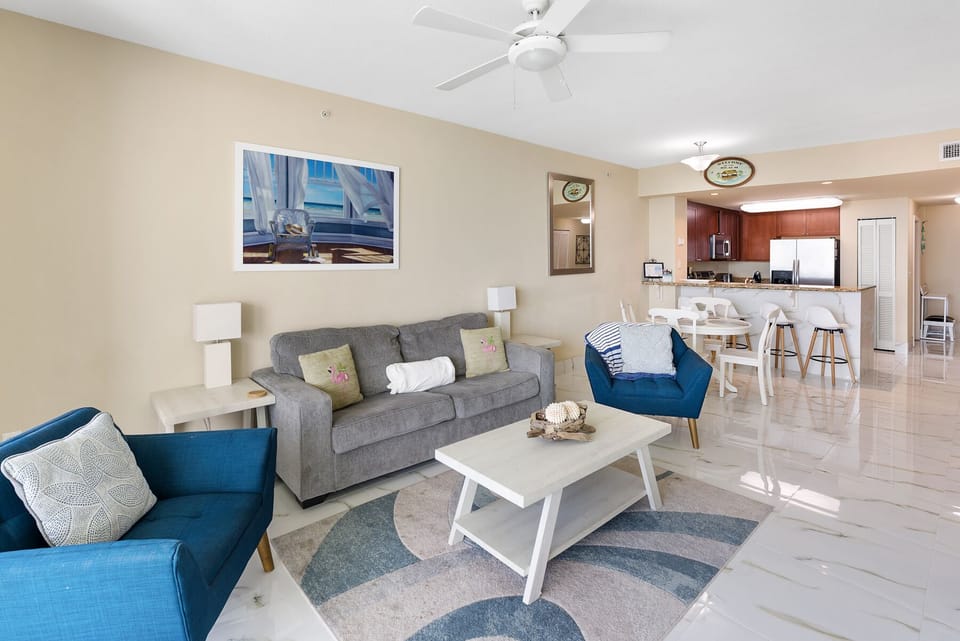 Sink into plush seating where coastal blues meet modern comfort, your perfect retreat after beach days.