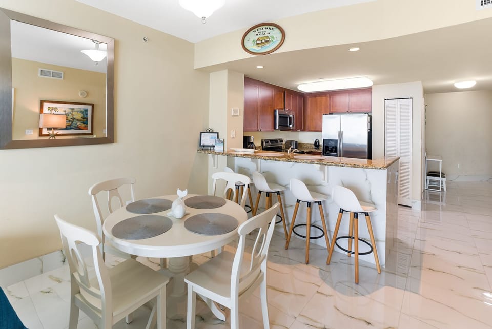 Your open-concept kitchen and dining space features granite counters, stainless steel appliances, and a breakfast bar perfect for morning coffee together.
