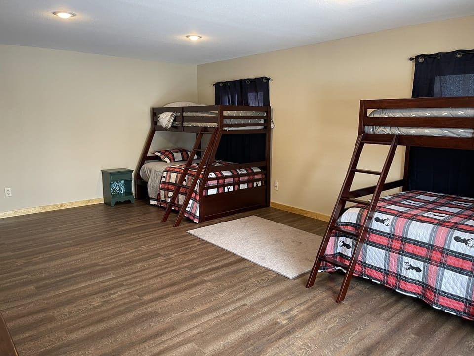Third bedroom with two twin over full bunk beds, closet, dresser and couch.