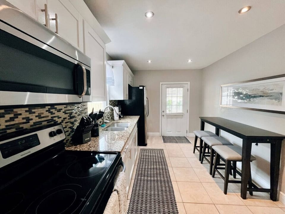 Modern, Fully Equiped Kitchen, Barstool Seating for Three, & Backyard Entrance