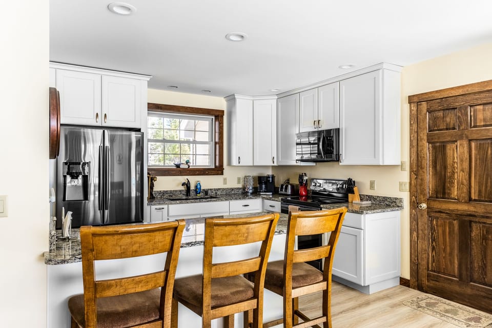Kitchen counter with 3 seats.