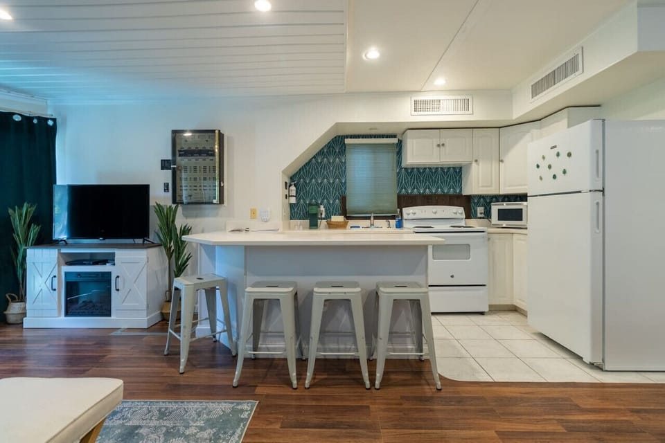 A seamlessly designed living room, just steps away from the kitchen, where every piece of furniture comes together to create a harmonious and inviting space for relaxation and gatherings.