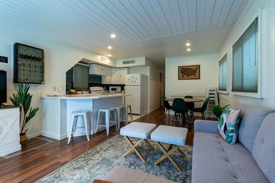 A seamlessly designed living room, just steps away from the kitchen, where every piece of furniture comes together to create a harmonious and inviting space for relaxation and gatherings.