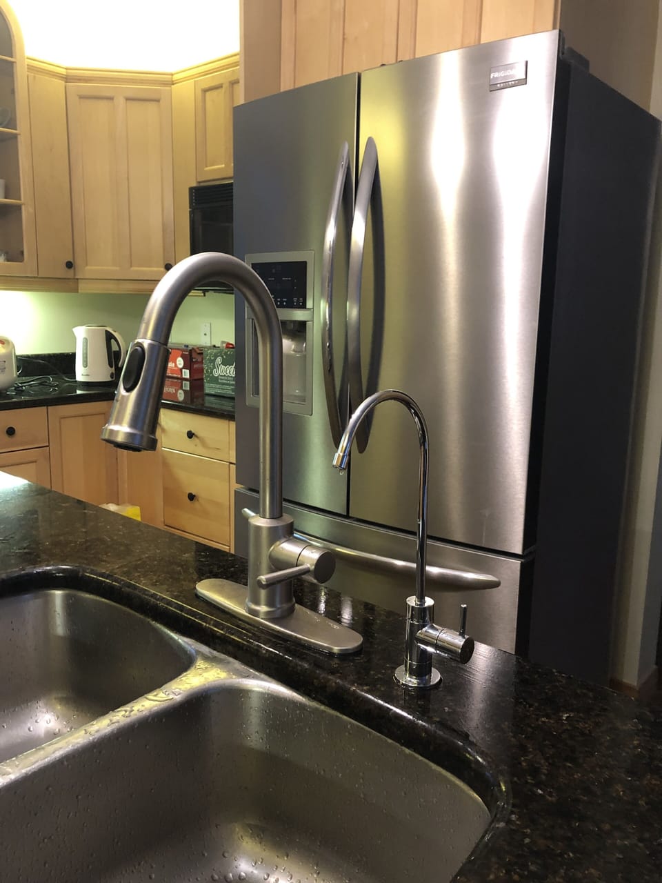 Two water faucets (both drinkable, the shorter one is more filtered) 