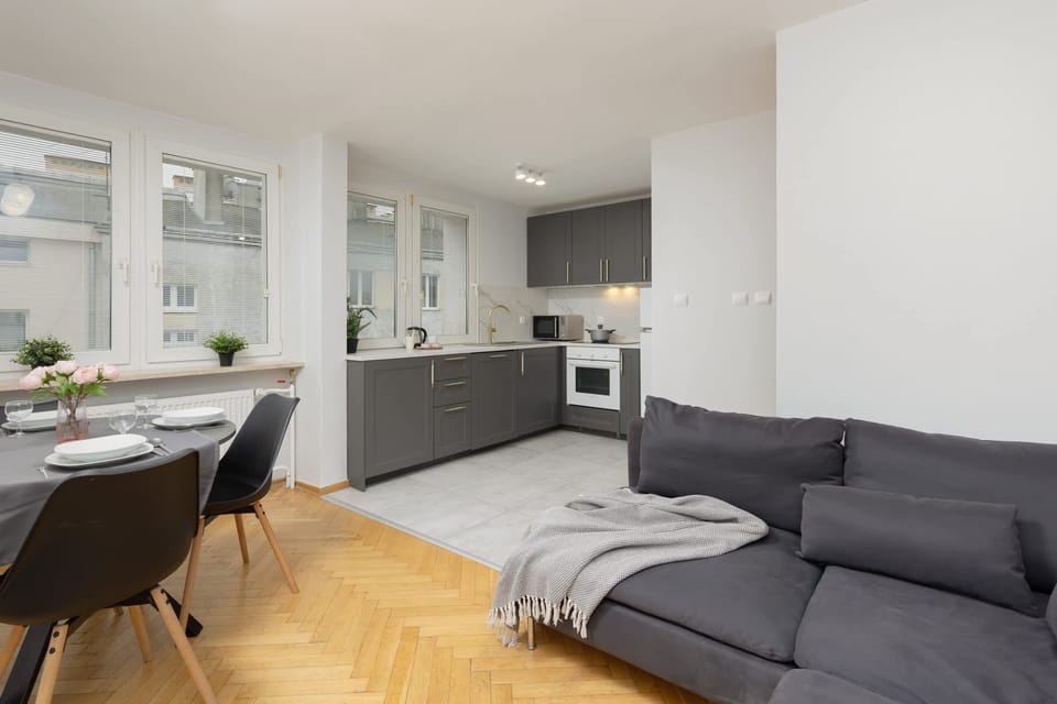 A spacious living area with an open layout, combining a kitchen and dining space.