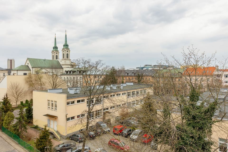 A picturesque view of a historic cityscape seen from a balcony.