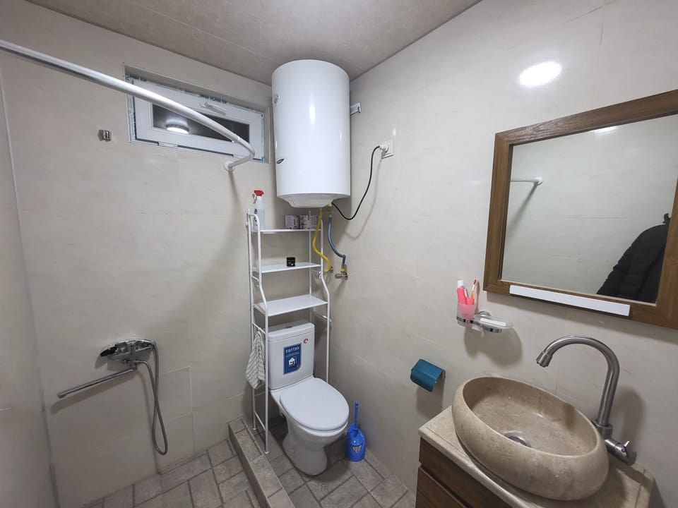 Shower, designer toiletries, hair dryer, slippers
