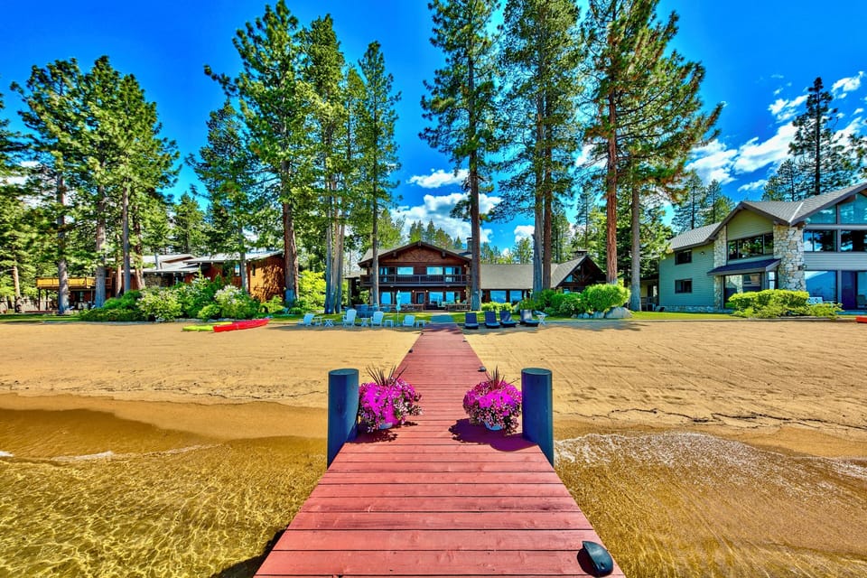 Lake Tahoe Lakefront Level grounds with lawn and stately Sierra trees lead to 100' of breathtaking shoreline with a private pier and two Boat buoys. Lake Tahoe Legacy Sunsets sitting on the Lake