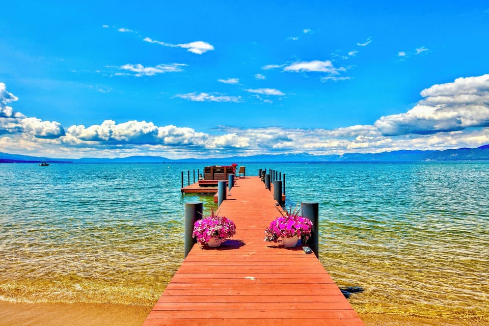 Lake Tahoe Lakefront Level grounds with lawn and stately Sierra trees lead to 100' of breathtaking shoreline with a private pier and two Boat buoys. Lake Tahoe Legacy Sunsets sitting on the Lake
