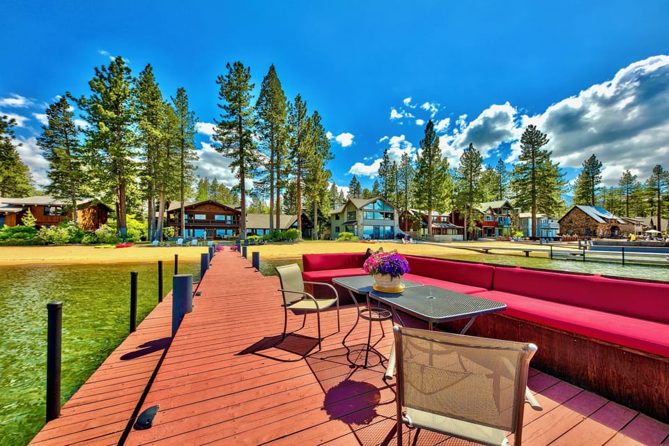Lake Tahoe Lakefront Level grounds with lawn and stately Sierra trees lead to 100' of breathtaking shoreline with a private pier and two Boat buoys. Lake Tahoe Legacy Sunsets sitting on the Lake