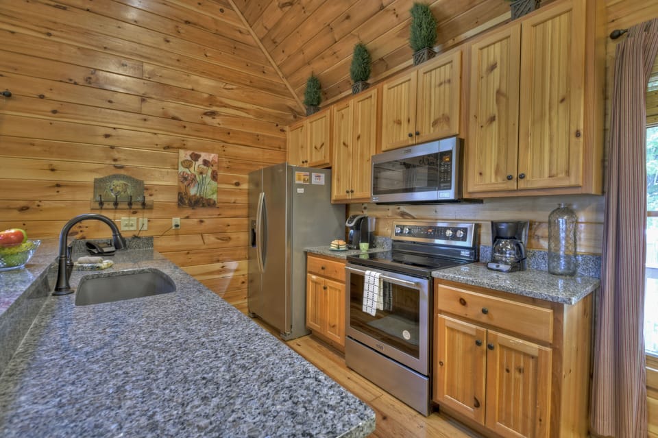 Stainless steel appliance and granite countertop in this luxury cabin rental.