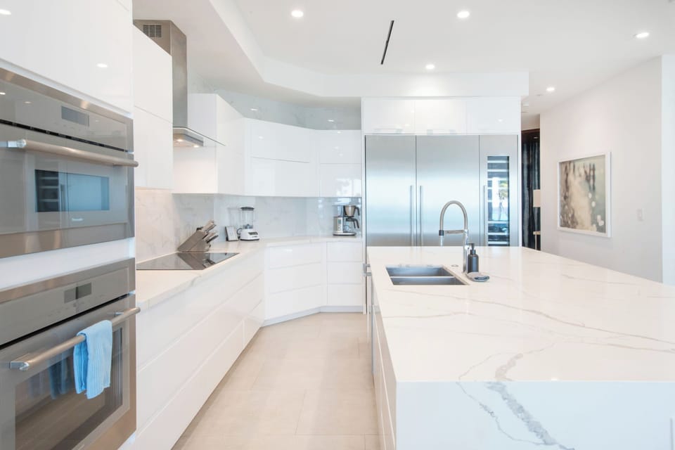 Gourmet kitchen with white cabinets and top of the line appliances.