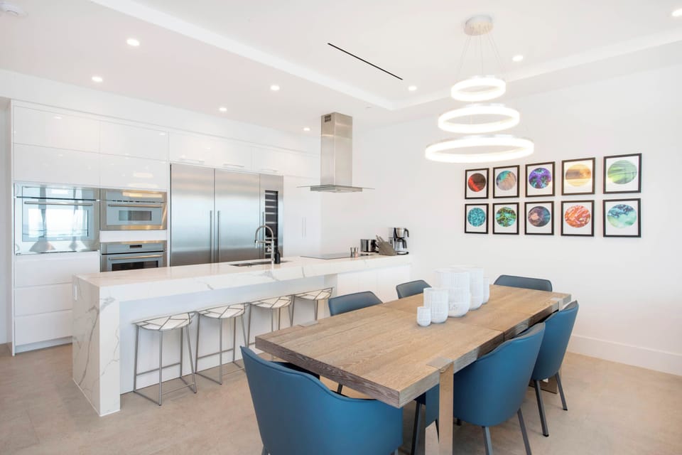 Dining table with seating for 6. The kitchen island provides additional seating.