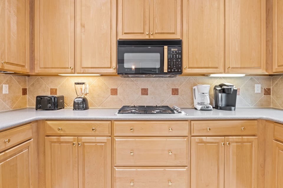 Your fully equipped kitchen features granite counters, gas stove, and coffee maker—everything you need for home-cooked meals during your stay.
