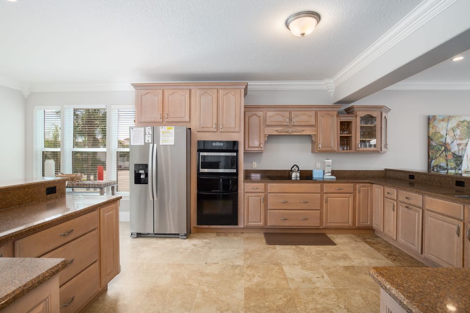Your spacious kitchen features warm wood cabinetry, granite countertops, and modern stainless steel appliances for delightful home cooking.