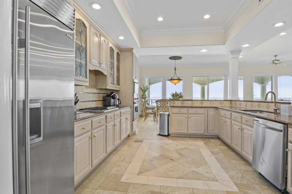 Your fully equipped gourmet kitchen awaits with granite counters, stainless appliances, and ocean views for memorable meal prep.