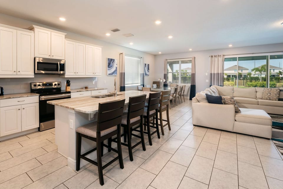 Spacious kitchen and living area with ample seating, perfect for family gatherings and entertaining.