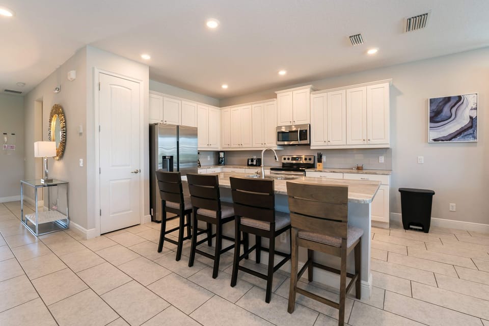 Spacious kitchen with modern appliances and island seating, ideal for family gatherings and culinary creations.