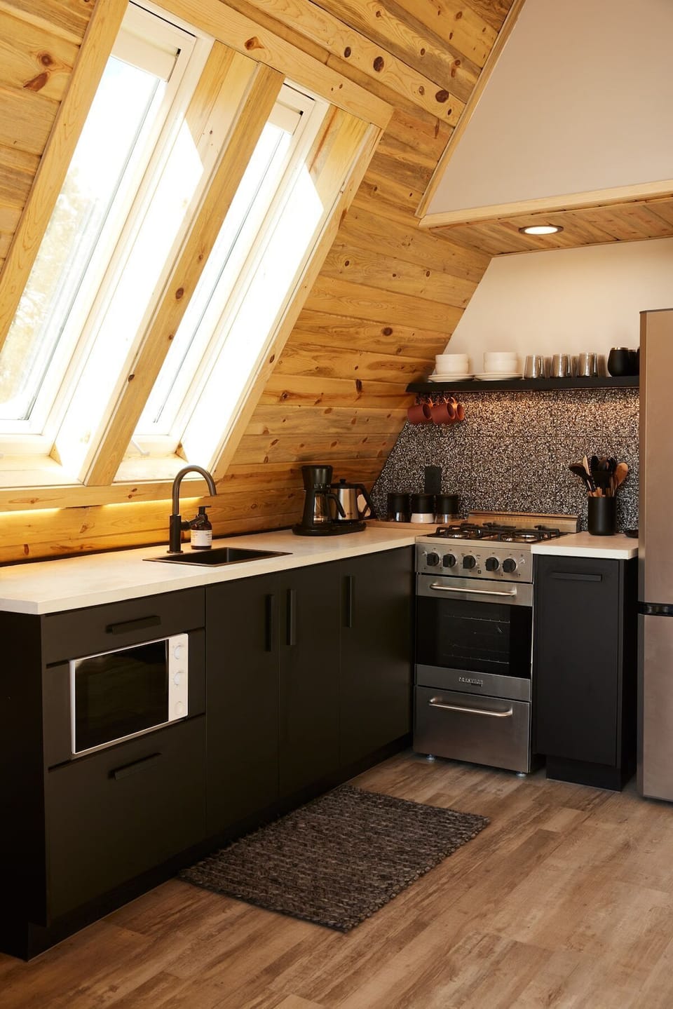 The kitchen is equipped with all modern appliances such as a fridge, stove, oven, microwave, and essential utensils, cookware, toaster, and Nutri-bullet. Treat yourself to freshly brewed coffee with the Mr. Coffee automatic pour-over coffee machine. 