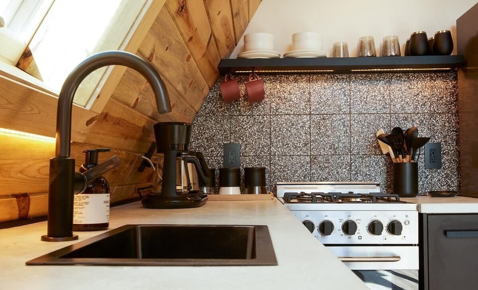 The kitchen is equipped with all modern appliances such as a fridge, stove, oven, microwave, and essential utensils, cookware, toaster, and Nutri-bullet. Treat yourself to freshly brewed coffee with the Mr. Coffee automatic pour-over coffee ma