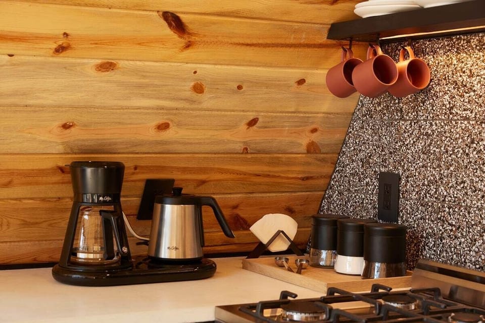 The kitchen is equipped with all modern appliances such as a fridge, stove, oven, microwave, and essential utensils, cookware, toaster, and Nutri-bullet. Treat yourself to freshly brewed coffee with the Mr. Coffee automatic pour-over coffee machine. 