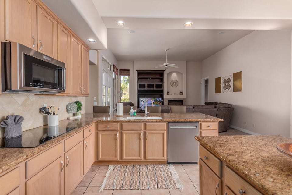 Spacious kitchen with KitchenAid stainless steel appliances.