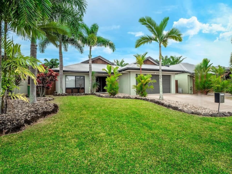 Framed by tropical landscaping and open lawn space, the home welcomes you with a calm coastal feel from the moment you arrive.