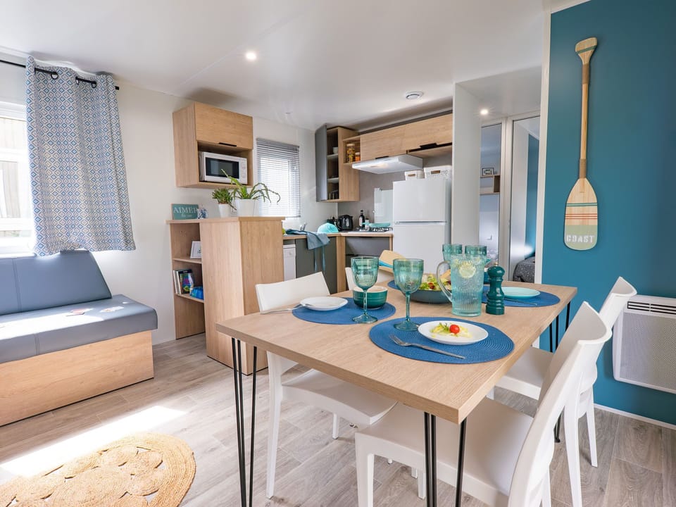 Bright and welcoming dining area with coastal decor, ideal for family meals and gatherings.