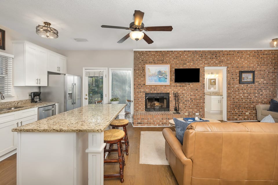 Kitchen with granite counters and brick accent wall
