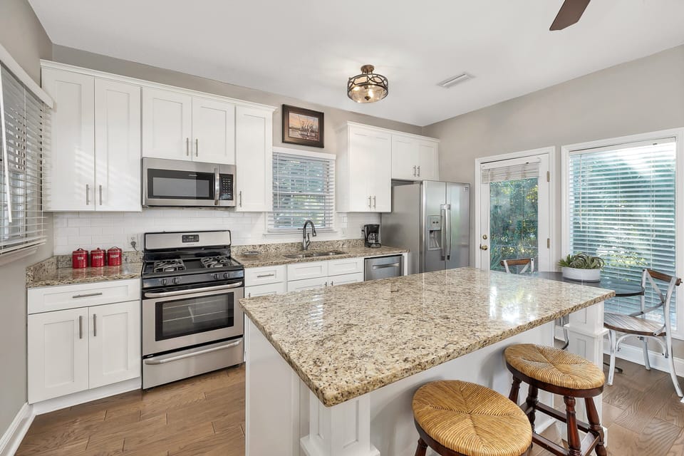 Kitchen with stainless appliances and island seating