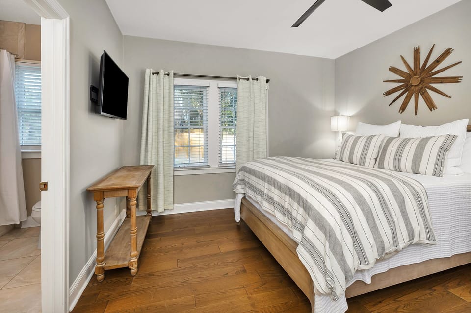 Primary bedroom with queen bed and TV