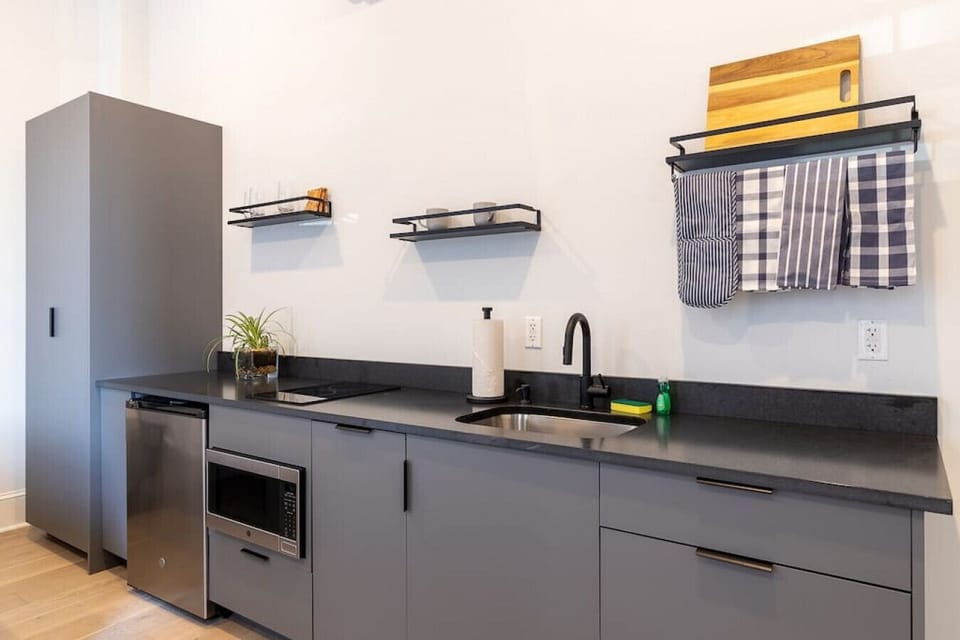 Fully equipped kitchen with sleek finishes and essential amenities.