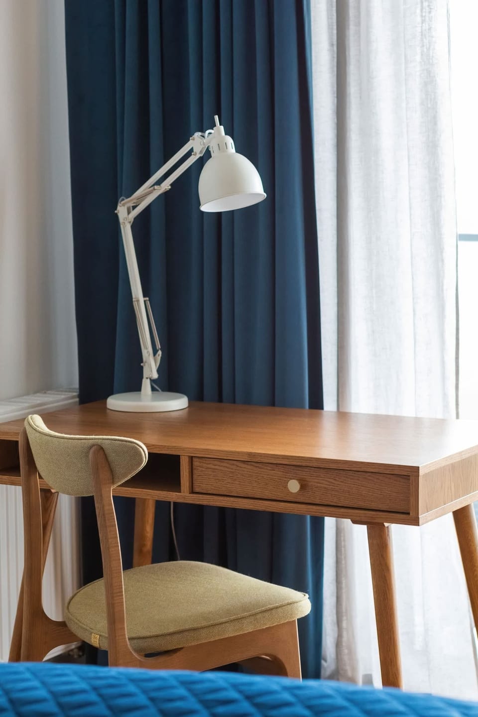 A similar view of the bedroom, emphasizing the desk and the chair which are perfect for remote work.