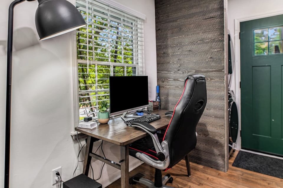Work from Anywhere Equipped: Setup includes a desk with Wireless Charging Station, Power Plug/Cable Connections, Docking Station, 27" Monitor, Wireless Keyboard & Mouse, Comfy Desk Chair, and BIG desk lamp.