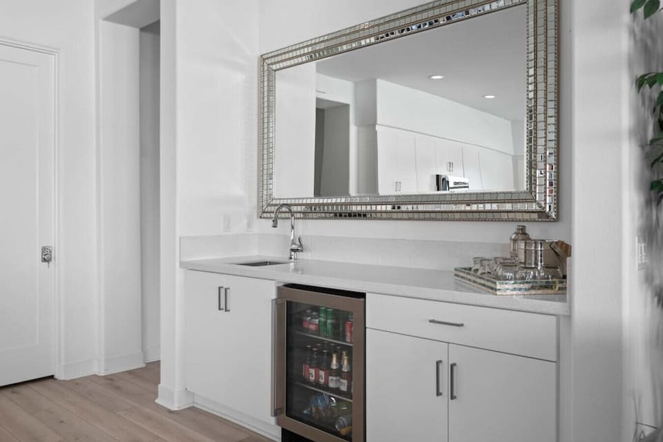 Stylish bar area w/ mirror, cabinetry & space to mix your favorite drinks