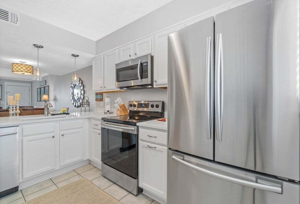 Kitchen with full amenities over looking the living room
