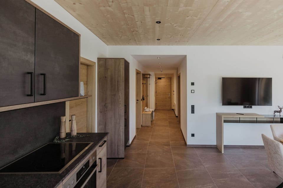 Panoramic Apartment, 4 Bedrooms, Patio, Mountain View (Hochsitz) | Living area | 50-inch Smart TV with cable channels, TV, heated floors