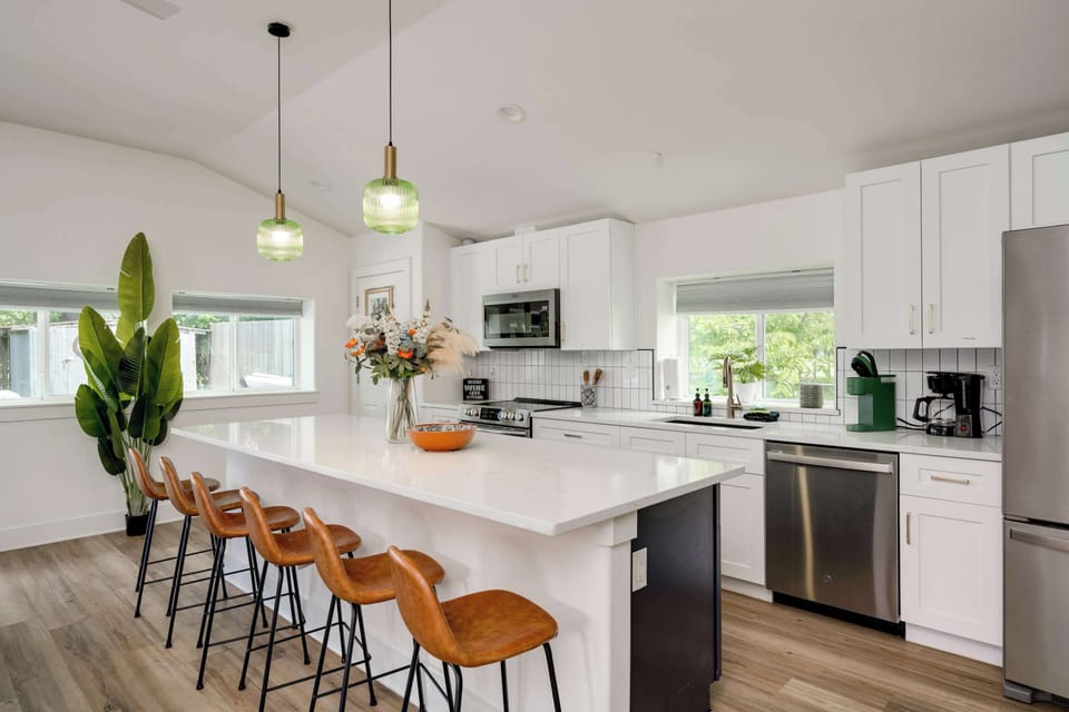 Stocked with basics: Cooking kitchen with large entertainment island with bar seating. Opens to living area. 