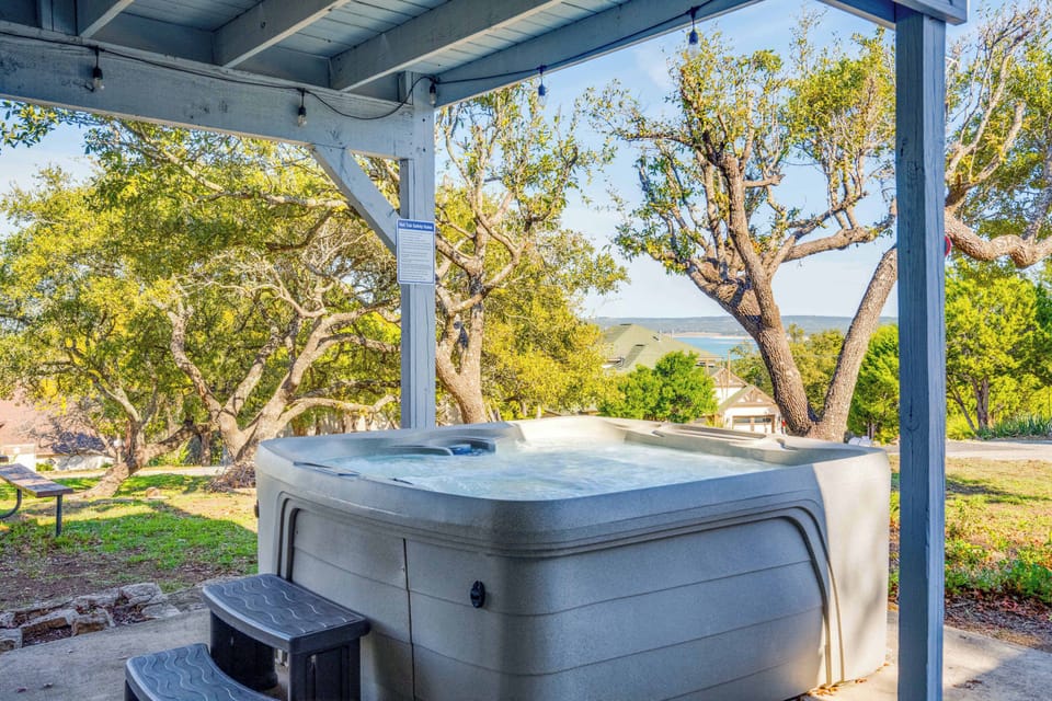 Hot tub area with small views of the lake + table/chairs for entertainment