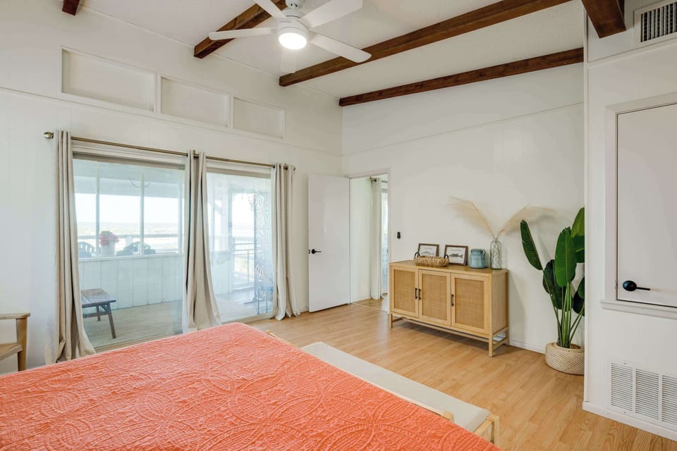 Master bedroom suite. Views of the lake, access to semi private screened in porch, tub/shower combo bathroom with double vanities (separate rooms). 