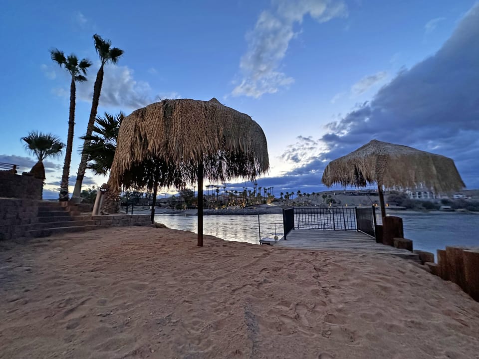 Sip a Cold Drink on the beach or the dock  under a  Palapa!