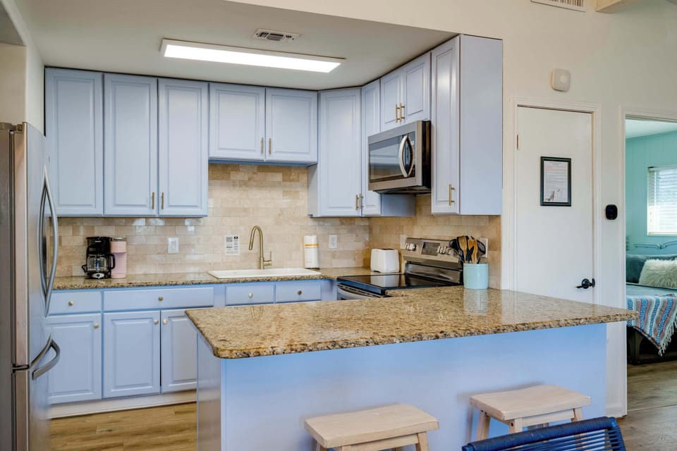 2 bar top seats to kitchen. Stocked kitchen with all the basics to cook meals!