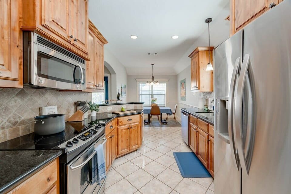 Kitchen opens up to the dining room & bar area off the living room. Coffee bar with Keurig & drip coffee maker (BYOC). We provide a fully stocked kitchen with all the basics to cook a basic meal. 