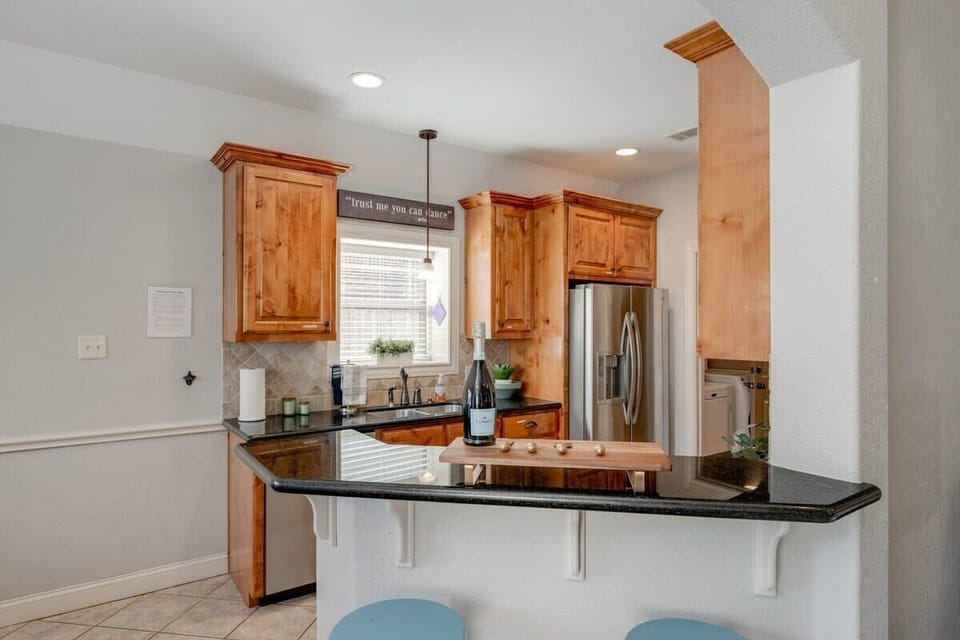 Kitchen opens up to the dining room & bar area off the living room. Coffee bar with Keurig & drip coffee maker (BYOC). We provide a fully stocked kitchen with all the basics to cook a basic meal. 