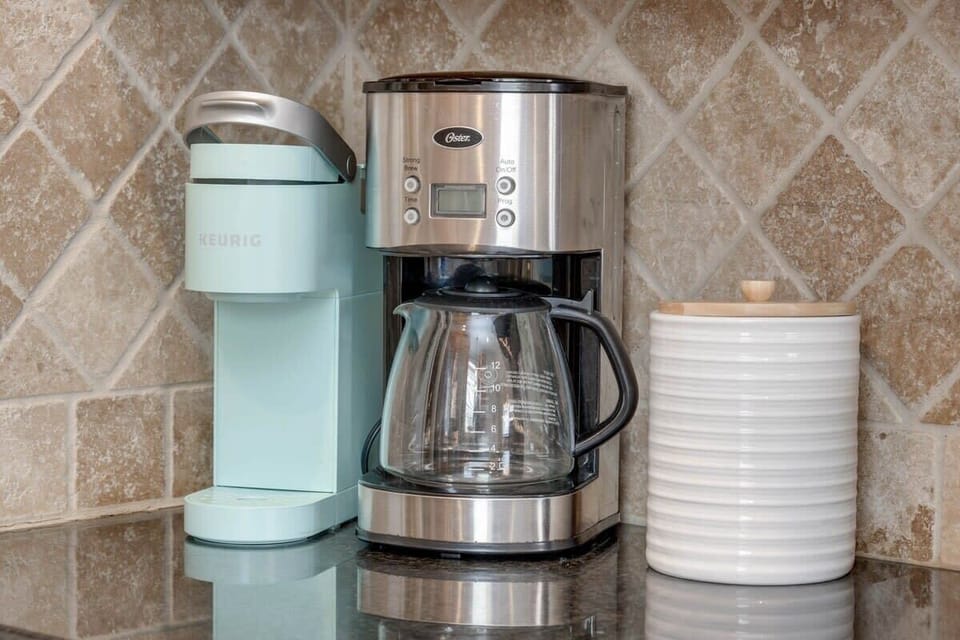 Coffee bar with Keurig & drip coffee maker (BYOC). We provide a fully stocked kitchen with all the basics to cook a basic meal. 