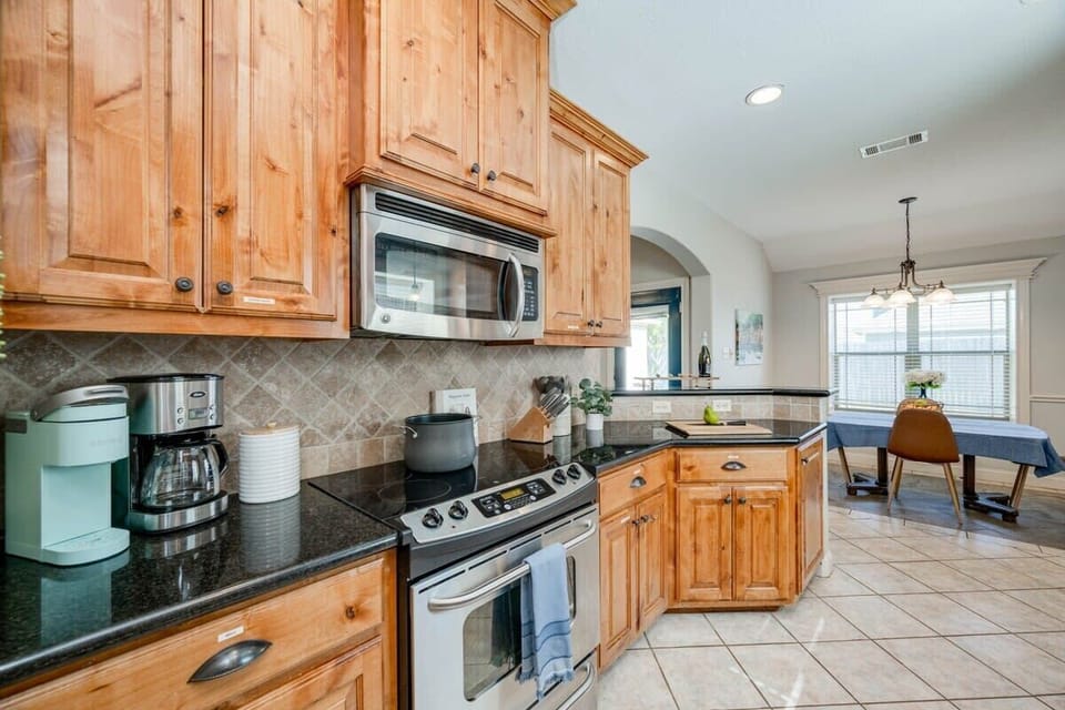 Kitchen opens up to the dining room & bar area off the living room. Coffee bar with Keurig & drip coffee maker (BYOC). We provide a fully stocked kitchen with all the basics to cook a basic meal. 