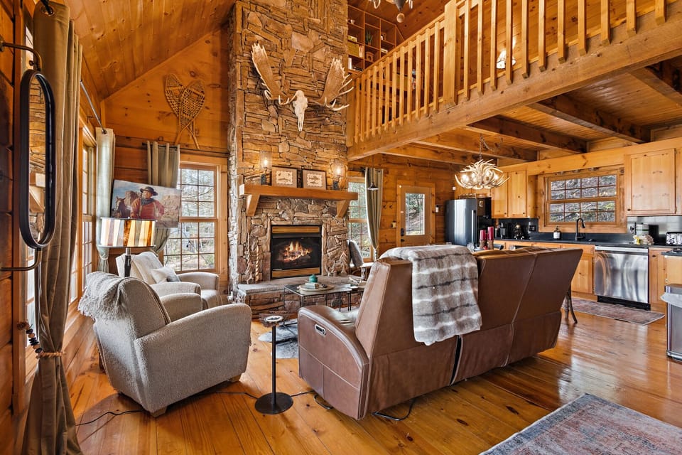 Reclining Leather Sofa, Comfy Chairs, and TV in the Living Room with Open Loft Above