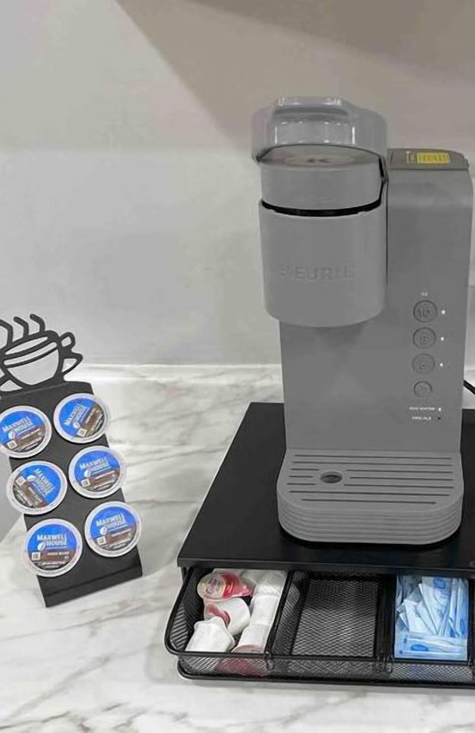 Complementary coffee pods, creamers, sugar, napkins, and stirring sticks and condiments